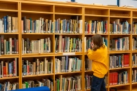 bookcase with student Marywood Announces New Programs