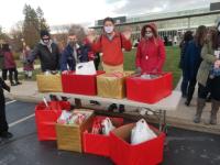 student at table provide gifts/cards to local children/teens Making Spirits Bright Campaign Helps Numerous Community Members