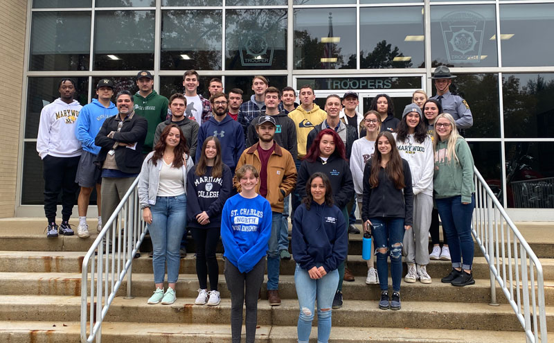 Group of local university students on steps of Pennsylvania State Police Academy