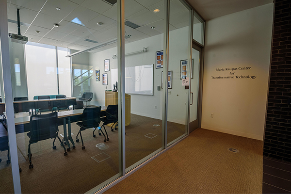Room-sized windows and a glass door separate this classroom from the second floor of the Learning Commons