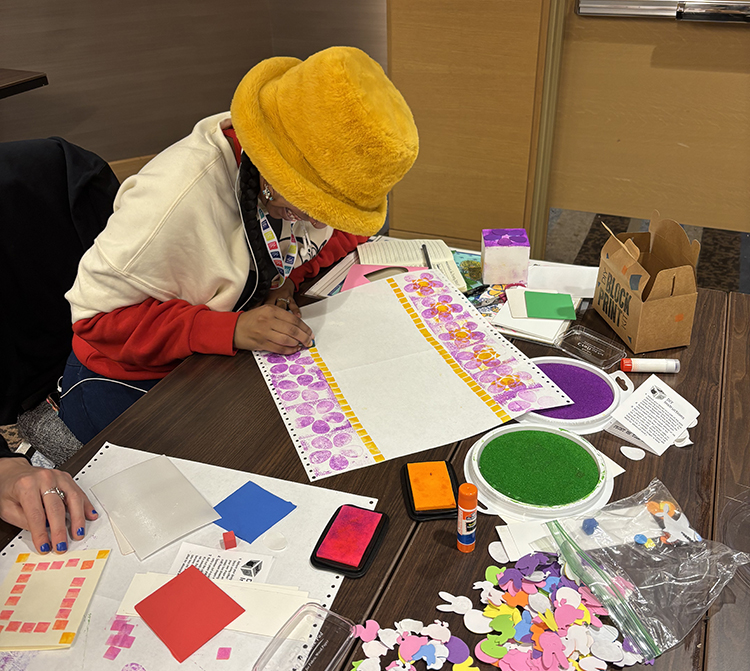 woman doing a craft of some sort at the conference