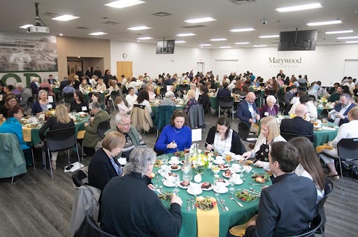 large gathering of people at tables during a luncheon