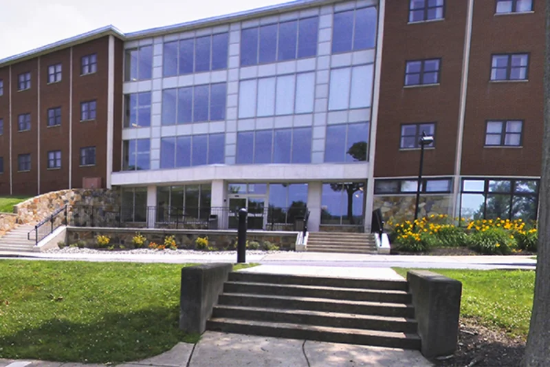 The front of Madonna hall and its surrounding plant-life