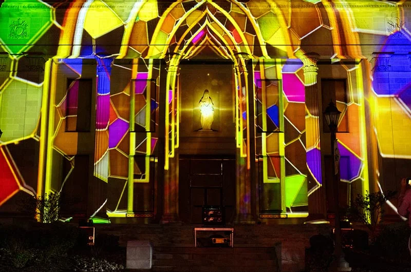 Multi-colored stained glass 3D lighting projection art on the front of the Liberal Arts Center Marywood University Celebrates Successful Completion of LIGHTING UP SCRANTON 2025