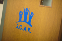 The SOAR logo on a door