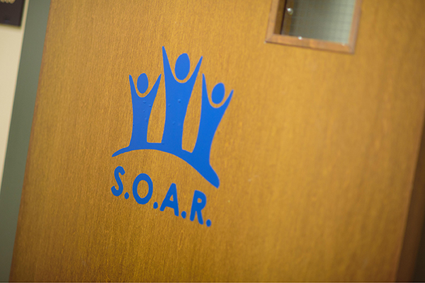 The SOAR logo on a door