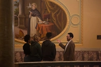 Students listen to a professor lecture on the art displayed in Marywood's Rotunda