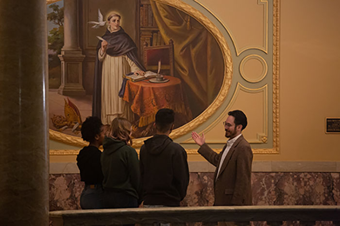 Students listen to a professor lecture on the art displayed in Marywood's Rotunda