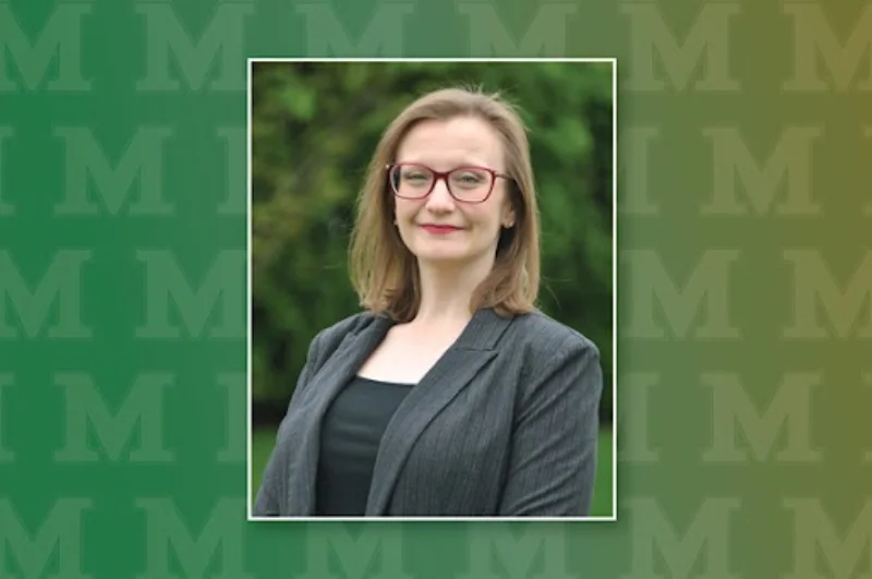 headshot of a woman wearing glasses and a gray blazer against a green backdrop with the Marywood M logo Marywood Doctoral Student Earns Research and Scholarship Award from Penn State Berks