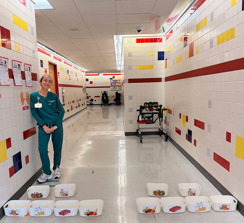 student in hallway with containers