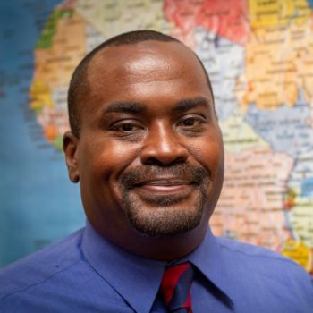 headshot with a map behind it