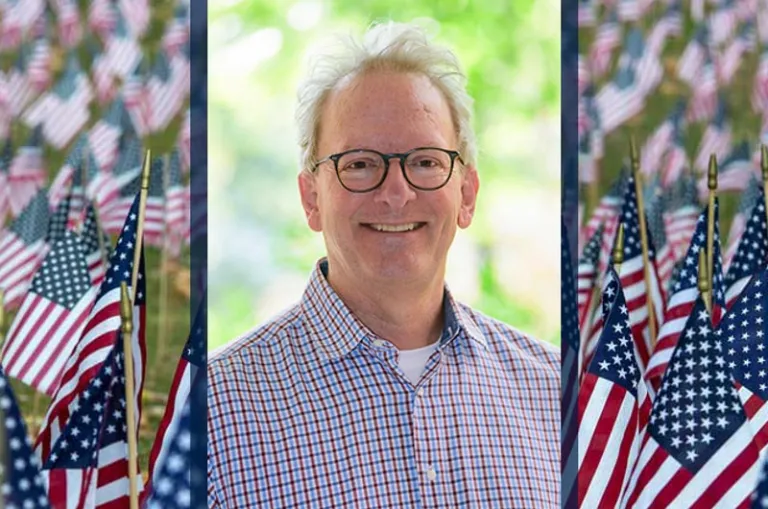 Dr. Jeffrey Rutter, Psychology Professor and U.S. Air Force Veteran, pictured with a background of Flags for the Fallen, is the guest speaker for Marywood's Veterans Ceremony on November 10.
