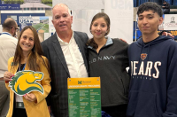 A woman and man with two adolescent students are pictured holding Marywood University branded materials, including a horse (Pacer) die-cut information card.