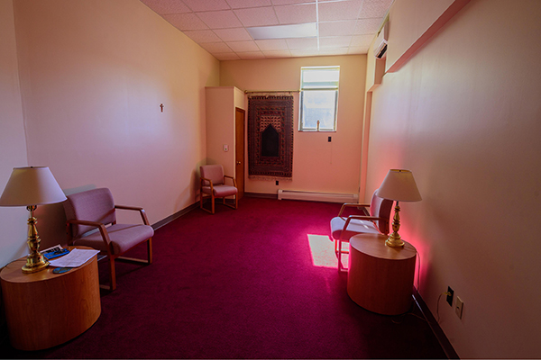 The Marywood Reflection room, tinted pink, with a few chairs and accompanying lamps