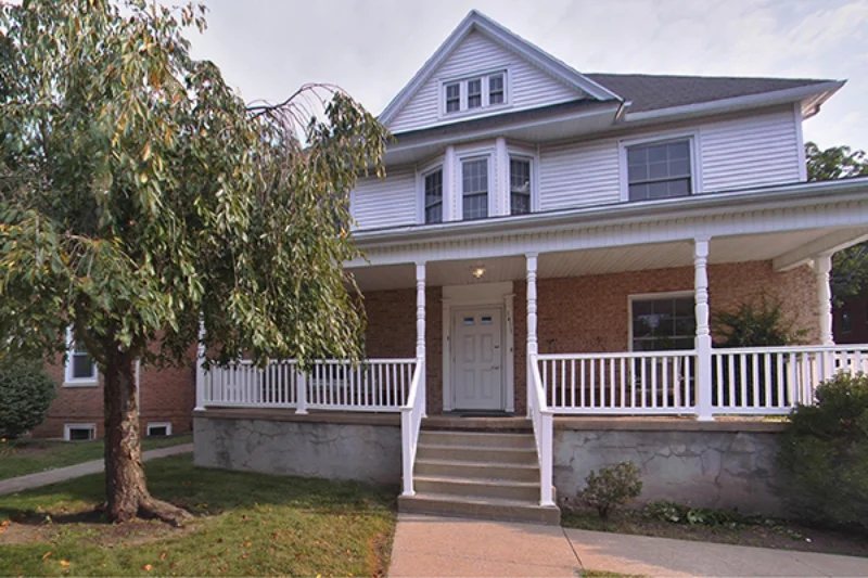 The front of Marywood's perpetual help hall. The porch has a white fence with white support beams on it