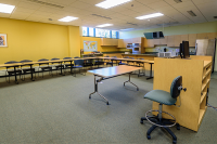 An L-shaped desk with chairs in the Marywood healthy families classroom
