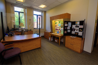 An office with a ministry posterboard presentation and Marywood-related flyers