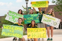 Students holding colorful green and yellow signs with Pacer Pride and Welcome to Marywood on them. Marywood University Earns Strong National and Statewide Rankings from Niche