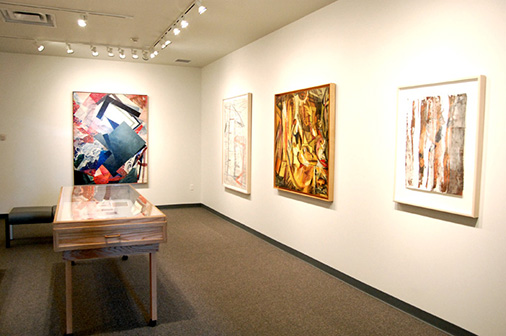 A room full of exhibition with paintings
