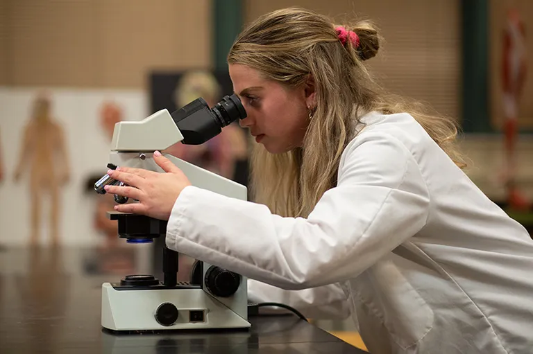 lady looking into a microscope
