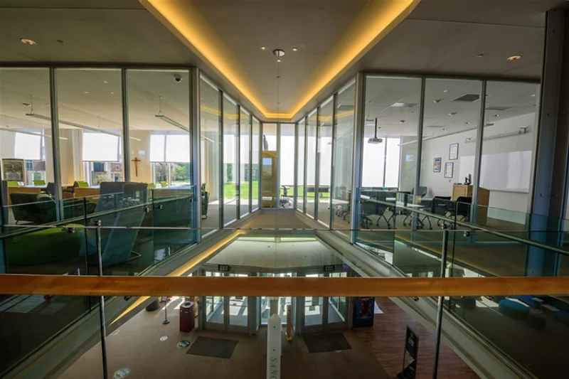 An overlook of the first floor of the Learning Commons from the second floor