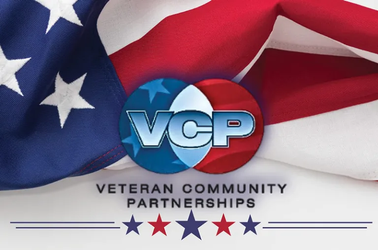 background of a USA flag with a veteran community partnerships logo and blue and red stars