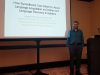 Dr. Ramachandra stands to the right of a projection screen. CSD Professors Present at 2019 PA Speech-Language Pathology Convention
