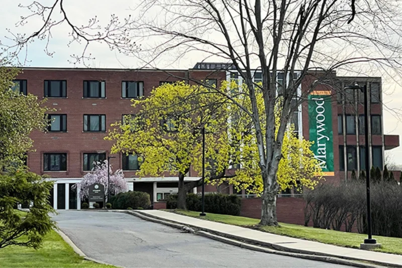 The front of Loughran hall with a Marywood banner and colorful trees