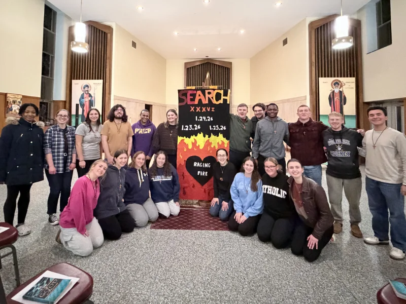 students gathered by search retreat poster Marywood Students Continue Tradition with Search XXXVI Retreat