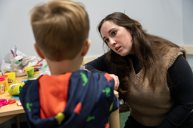 girl talking to younger boy