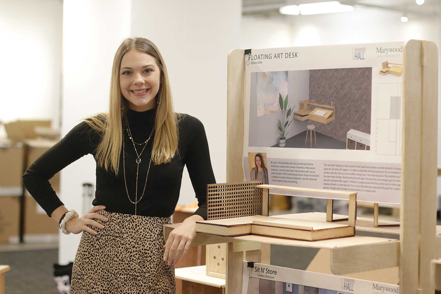 Brenna Heller proudly displaying her floating desk design