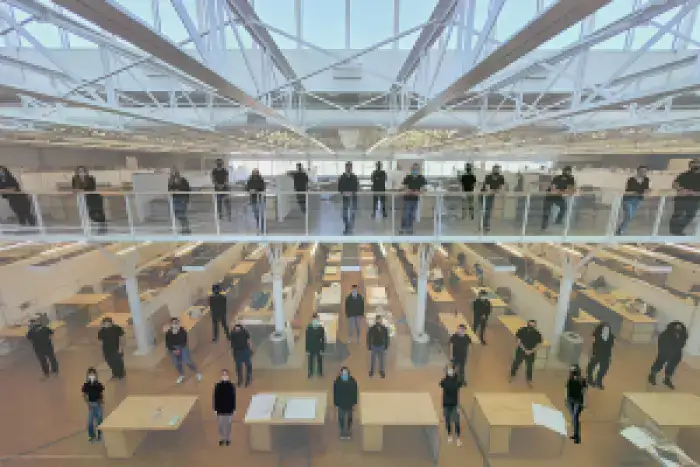 Marywood architecture students stand by their desks for a picture