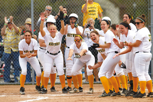 a group photo of Marywood University baseball players cheering