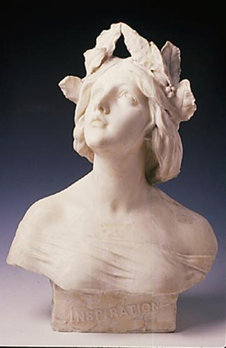 A sculpture of the upper body of a lady distantly looking to the sky