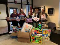 five student with gifts Students Collect Gifts for Local Organizations
