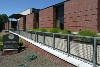 The front of the McGowan Center with a metal fence serving as a railing over an edge