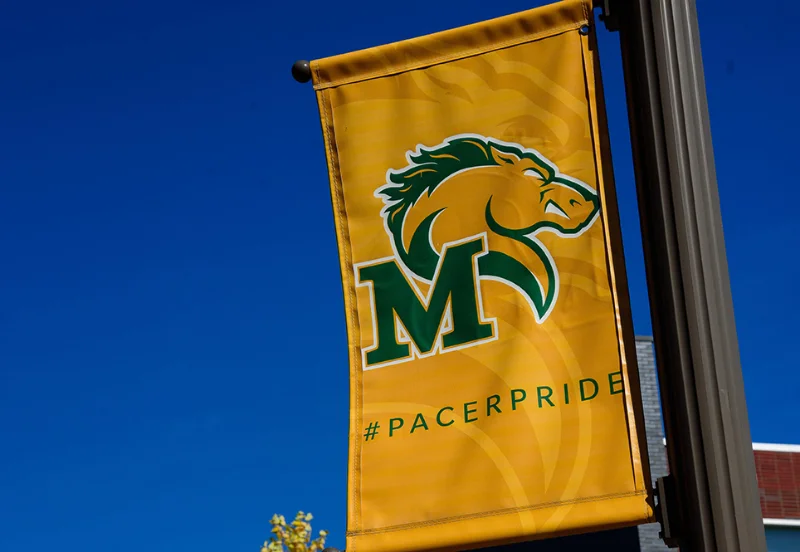 A golden banner with Maxus, the pacer logo, on it