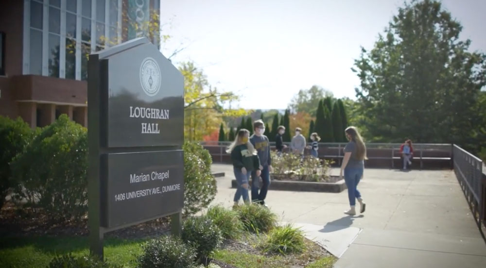 Students walking in front of Loughran Hall