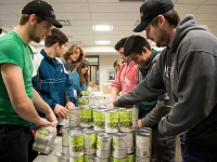 students packing canned goods for service