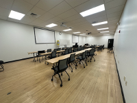 A visual arts classroom with computers and paintings on the wall