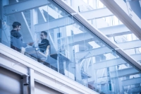 two students on architecture second floor blue tinted glass