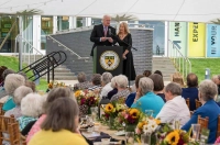 People at a podium in front of a crowd sitting at tables with flowers Celebrate Marywood Event Honors Richard and Erin Kane and Raises Nearly $400,000