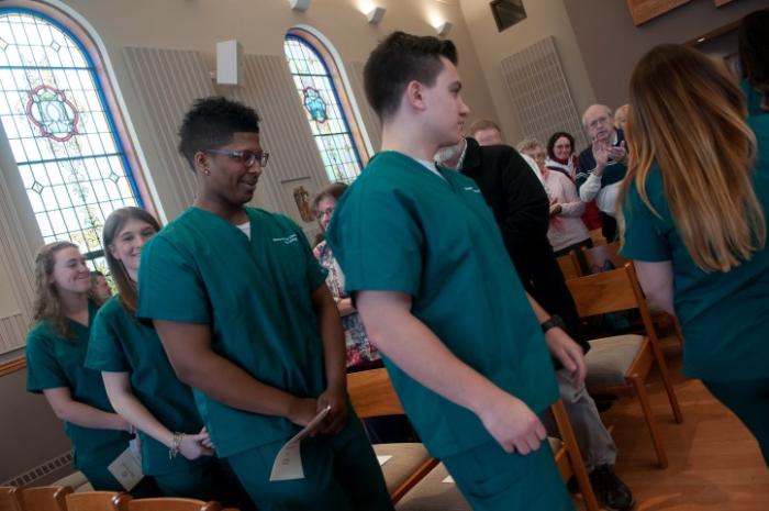 Nursing Students wait in line to have their hands blessed.