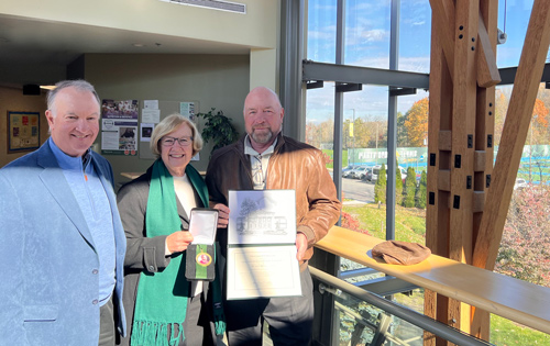 Son-in-law, Louis Powlette, daughter, Patricia Powlette, and son, Carl Cramer in front of the Nutrition and Dietetics Wing