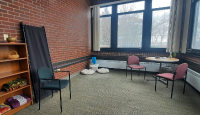 The Marywood Reflection room, tinted pink, with a few chairs and accompanying lamps