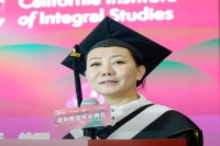 A woman speaking from a podium during the Zijing Education Graduation Ceremony in Beijing, China.