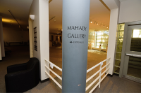 A white pillar in the Mahady art gallary stating its name