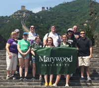 The Wind Ensemble Posing at the Great Wall in China Wind Ensemble Climbs to New Heights