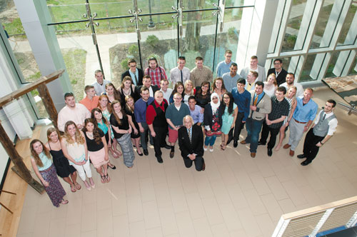 a group of students and their profession stand for a group photo taken from an aerial view.