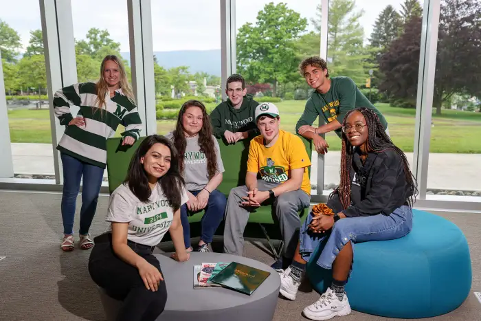 Seven students in Marywood attire in the Learning Commons